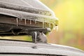 Frozen drops of icy conditions on the trunk and roof of a car, bright sunlight, weather anomalies