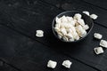 Frozen dumplings tortellini and ravioli in black bowl  on black wooden table background   with copyspace and space for text Royalty Free Stock Photo