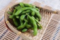 Frozen edamame beans in the basket on makisu meal mat ready to serve at Japanese restaurant in Bangkok, Thailand
