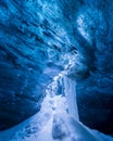 A frozen fall in a blue cave below VatnajÃ¶kull Glacier