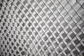 Frozen fence made of metal mesh covered with frost crystals, an early sunny cold morning, on a blurred background Royalty Free Stock Photo