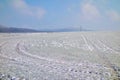 Wind turbine on a frozen field on a cold clear winter Royalty Free Stock Photo