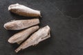 Frozen fillet fishes on slate stone background. Seafood, top view, flat lay, copy space