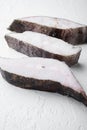 Frozen fillets of white fish, pollock, on white stone table background