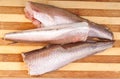 Frozen fish hake on cutting board Royalty Free Stock Photo