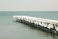 Frozen fishing pier with hanging icicles