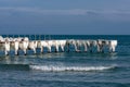 Frozen fishing pier with hanging icicles in a sunny winter day