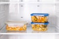 Frozen food in a container in the freezer. Ready meal. Refrigerator with frozen food