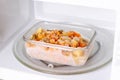 Frozen food in containers in the microwave, close up Royalty Free Stock Photo
