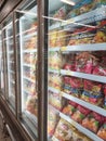 Frozen food displayed on the rack inside the large chiller in the supermarket.