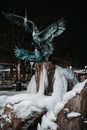 Frozen fountain with geese at night