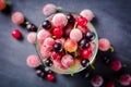 Frozen and fresh berries in a glass pial on a black background. Royalty Free Stock Photo