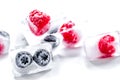 Fresh blueberry and raspberry in ice on table background Royalty Free Stock Photo