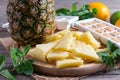 Frozen and fresh pineapple on a cutting board Royalty Free Stock Photo