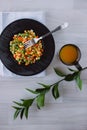 Frozen fried vegetables on black plate. Vegan breakfast with juice. Vegetables food mix on white wooden background with plant Royalty Free Stock Photo