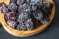 frozen frosly look blackberries closeup on wooden plate Royalty Free Stock Photo