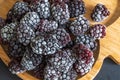 frozen frosly look blackberries closeup on wooden plate Royalty Free Stock Photo