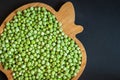 frozen frosty green peas on wooden plate closeup Royalty Free Stock Photo