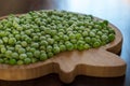 frozen frosty green peas on wooden plate closeup Royalty Free Stock Photo