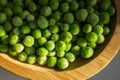 frozen frosty green peas on wooden plate closeup Royalty Free Stock Photo