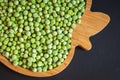 frozen frosty green peas on wooden plate closeup Royalty Free Stock Photo