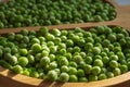 frozen frosty green peas on wooden plate closeup Royalty Free Stock Photo