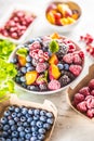 Frozen fruits blueberries blackberry raspberry red currant peach and herbs melissa Royalty Free Stock Photo