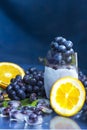 Frozen grapes in glass with orange and ice close-up Royalty Free Stock Photo