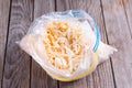 Frozen grated cheese in a package on the table Royalty Free Stock Photo