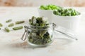 Frozen green beans in a glass jar. Freezing is a safe method of increasing the shelf life of nutritious foods