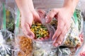 Frozen green beans in hand, closeup. Frozen vegetables in a plastic bag in refrigerator