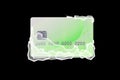Frozen green credit card in white ice blocks