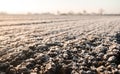 Frozen ground with hoarfrost on a farm field. Unpredictable weather, global climate destabilization. Weather forecast Royalty Free Stock Photo