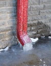 Frozen Gutter, Downspout. Gutter Pipe, Downspouts, House Foundation Wall Sometimes Freeze into Solid Blocks of Ice. Bad rain