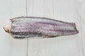 Frozen hake carcass on wooden table Royalty Free Stock Photo