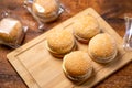 Frozen hamburgers on a wooden background. Semi-finished product for fast cooking. Fast food