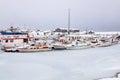 The frozen harbor of the Icelandic fishing village of HÃÂ¶fn in winter, with its boats laid up until the thaw Royalty Free Stock Photo