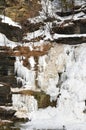 Frozen Hector Falls showing tiers of shale rock cut by glaciers