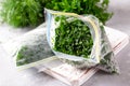 Frozen Herbs dill and parsley in a plastic bag. Concept of healthy eating