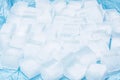 Frozen ice cubes for drinks arranged in a scattered pattern on a blue surface Royalty Free Stock Photo