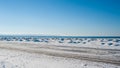 Frozen ice and sand dunes on beach in winter. Royalty Free Stock Photo