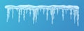 Frozen icicle cluster hanging down from snow-covered ice surface. Royalty Free Stock Photo