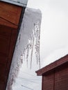 Icicles on the roof of the cottage Royalty Free Stock Photo