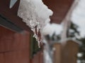 Icicles on the roof of the cottage Royalty Free Stock Photo