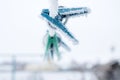 Frozen icy snow-covered clothespins outside in winter Royalty Free Stock Photo