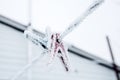 Frozen icy snow-covered clothespins outside in winter Royalty Free Stock Photo