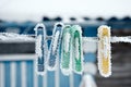 Frozen icy snow-covered clothespins outside in winter Royalty Free Stock Photo