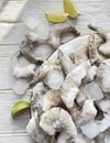 Frozen king prawns between ice cubes on the plate close up. Frozen big shrimps in ice and lime slices. Royalty Free Stock Photo