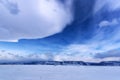 Frozen Lake Baikal. Beautiful stratus clouds over the ice surface on a frosty day. Royalty Free Stock Photo