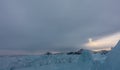 On a frozen lake - a block of shiny turquoise hummocks.